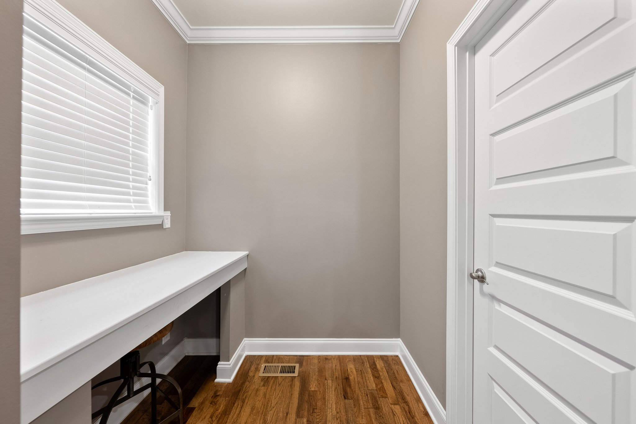 Small workspace nook with built-in desk and window