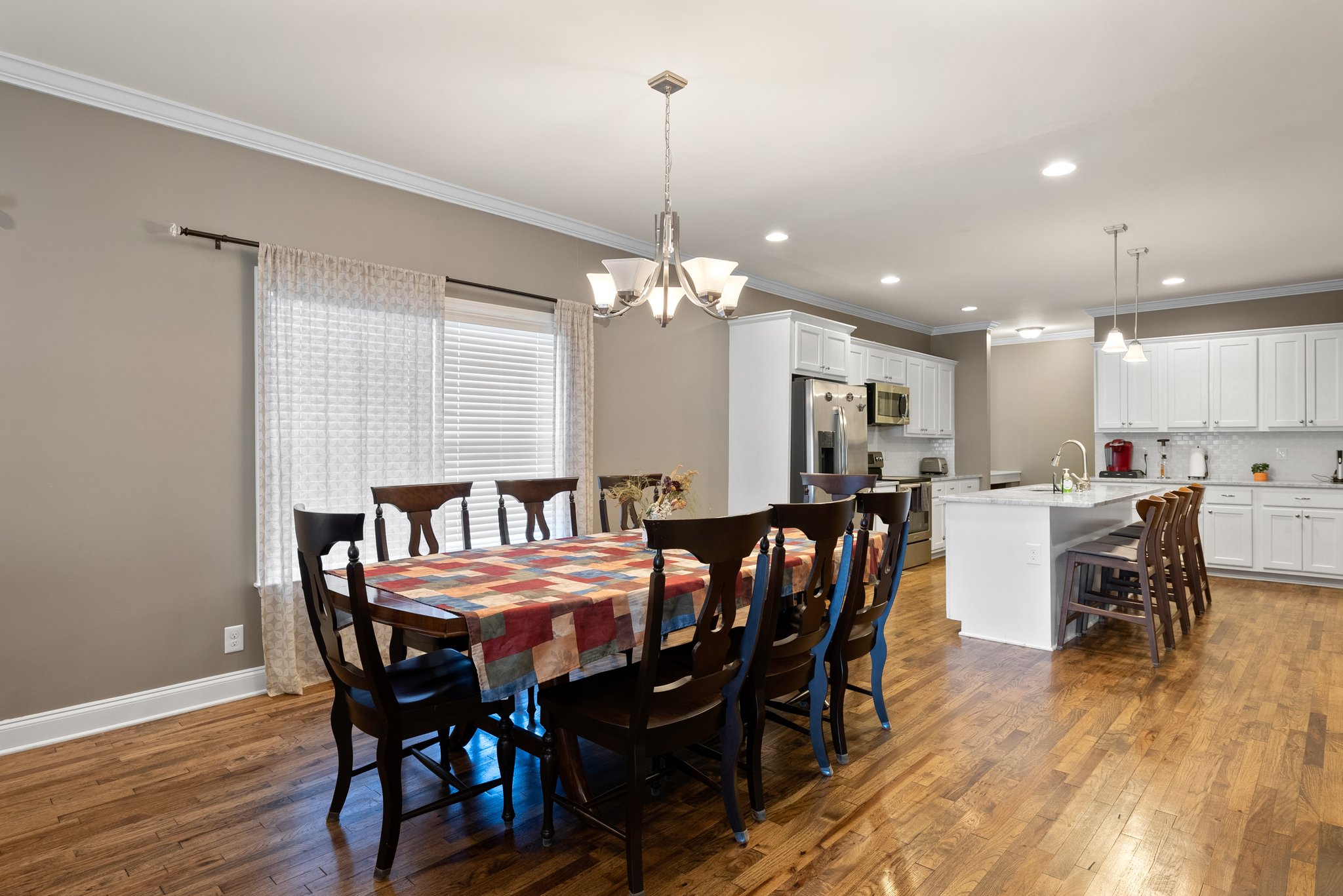 Dining area adjacent to open kitchen with ample natural light