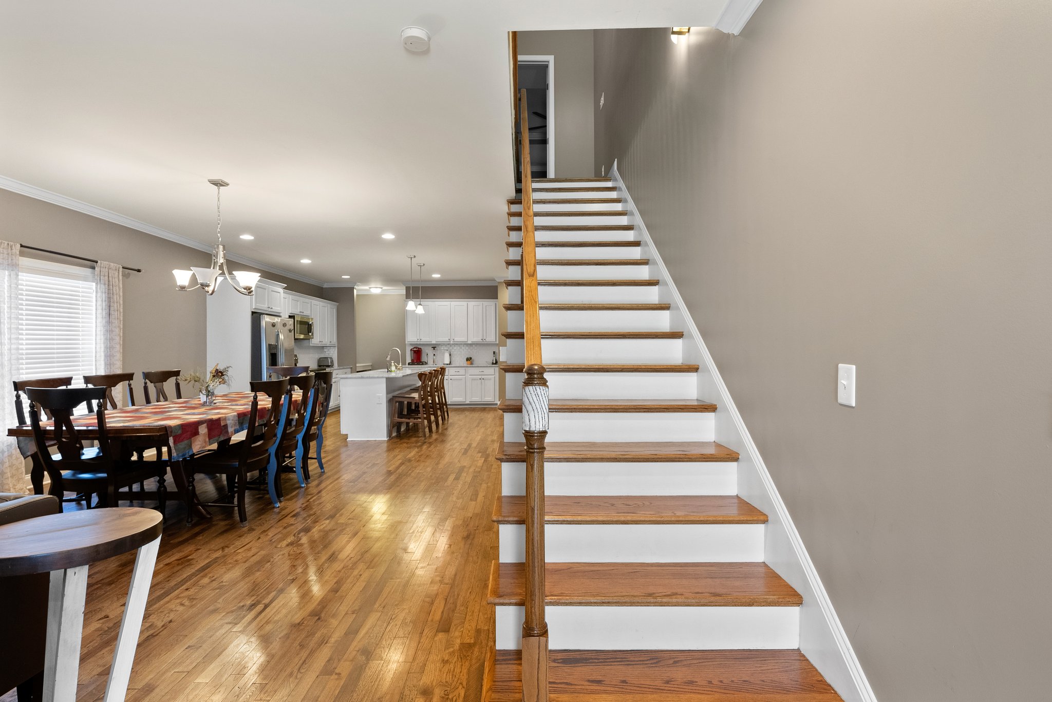 Staircase with wooden railing and white risers