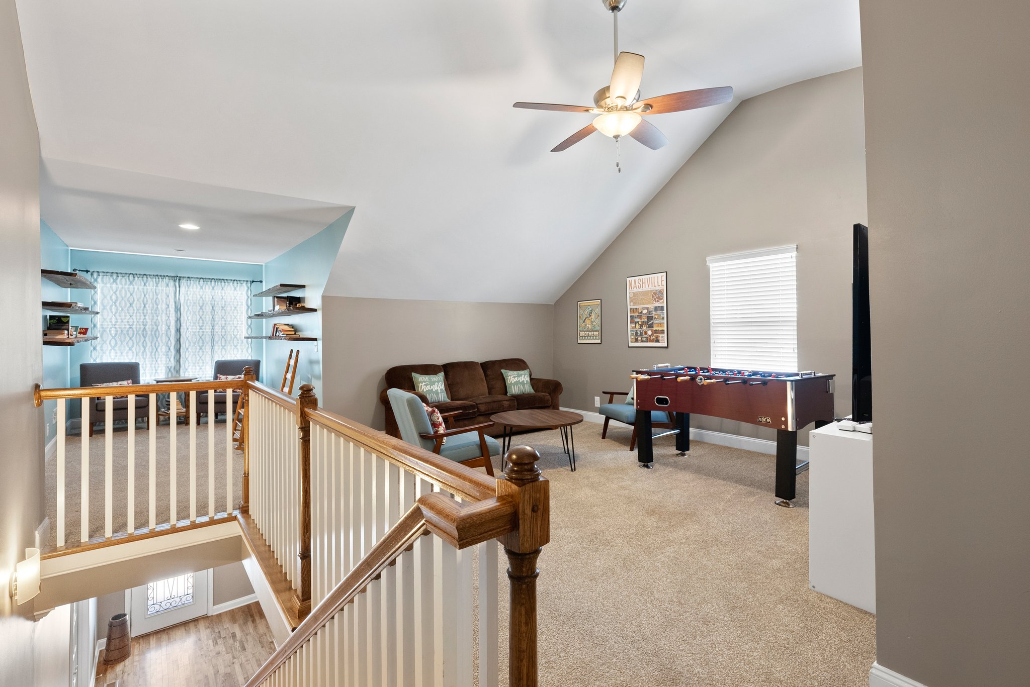 Upstairs loft with angled ceiling and cozy seating area