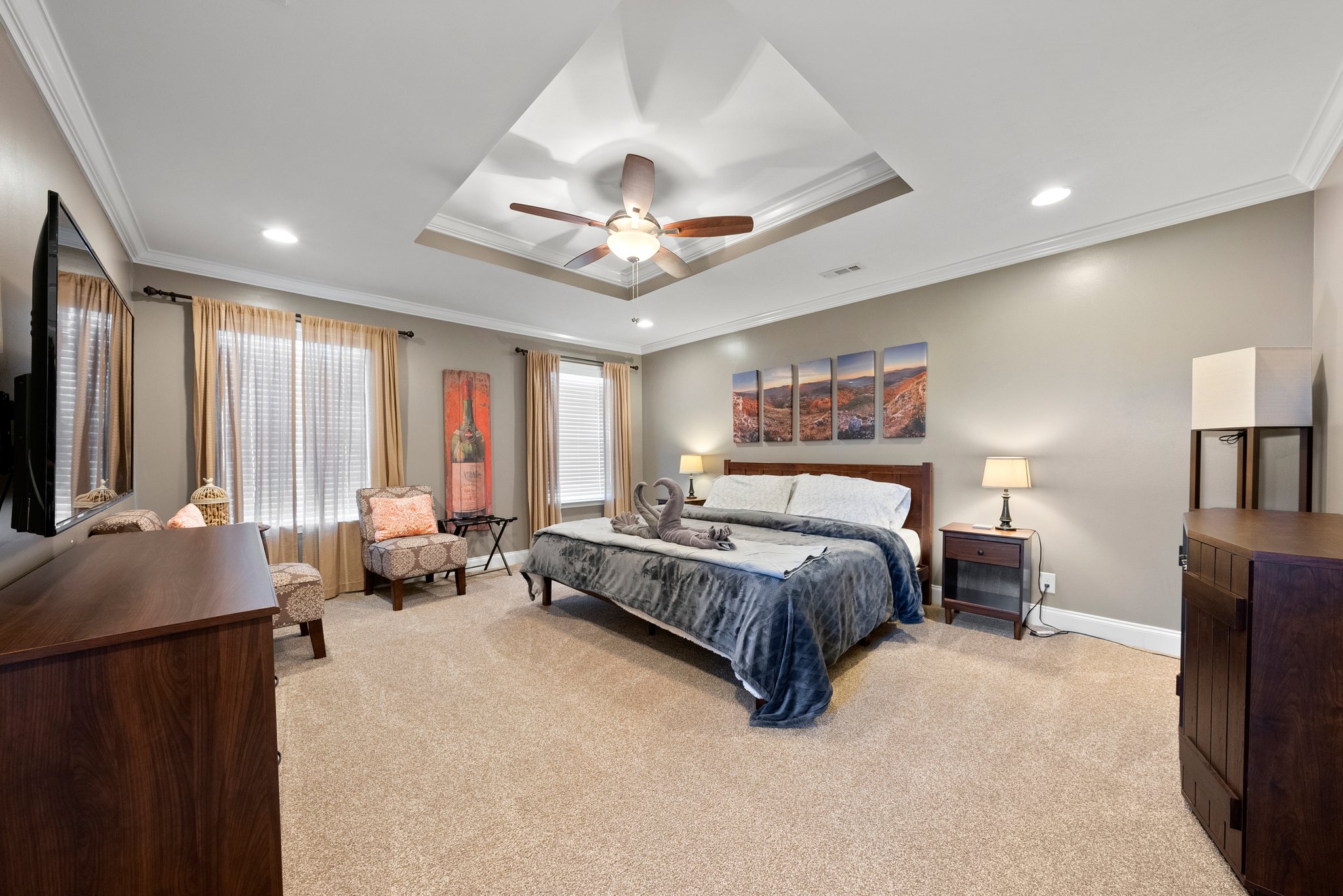 Spacious master bedroom with king bed and tray ceiling