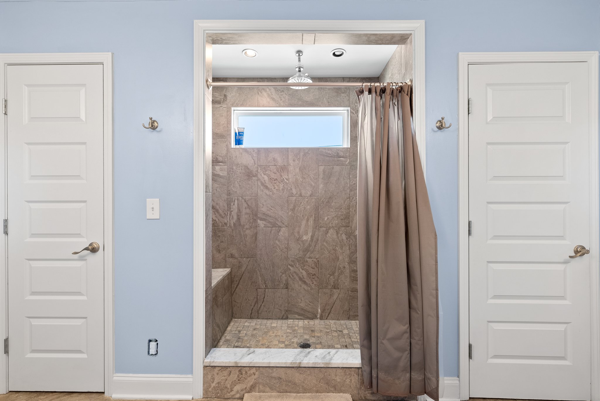 Master bathroom walk-in shower with tiled walls and rain shower head