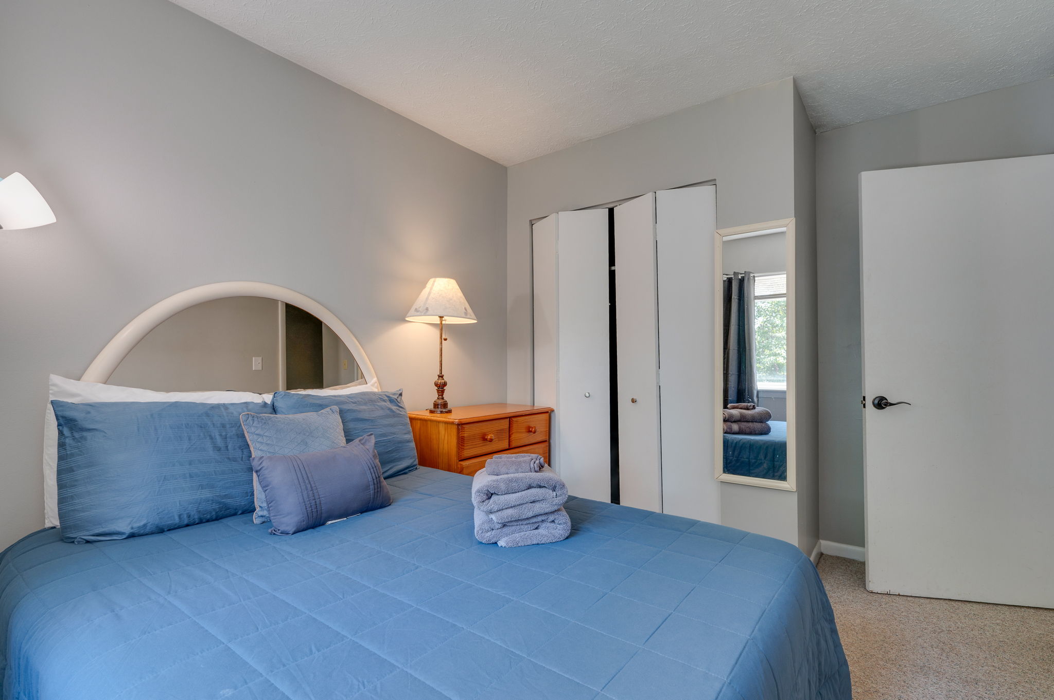 Spacious bedroom with soft lighting and closet storage