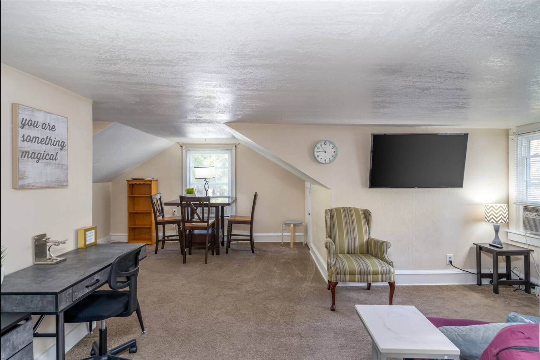 Open living area with a dining table, TV, and comfortable seating.