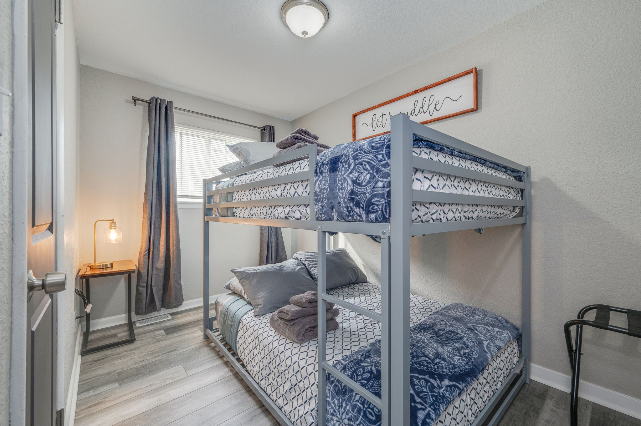 Small bedroom with stylish metal bunk beds and modern decor