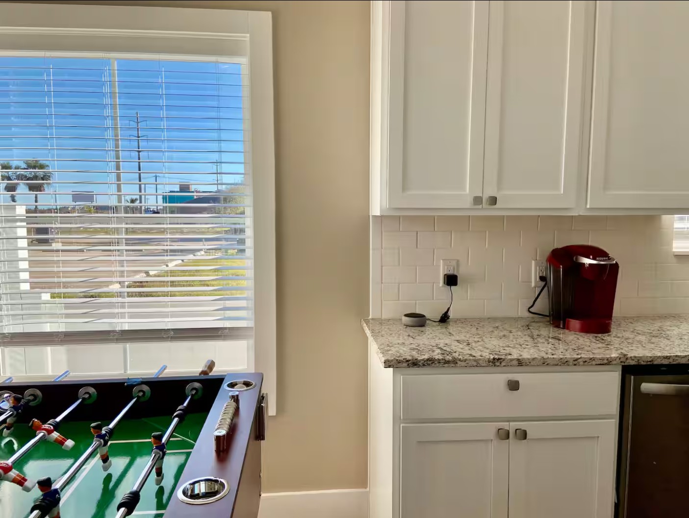 Kitchen counter with granite surface and Keurig coffee maker