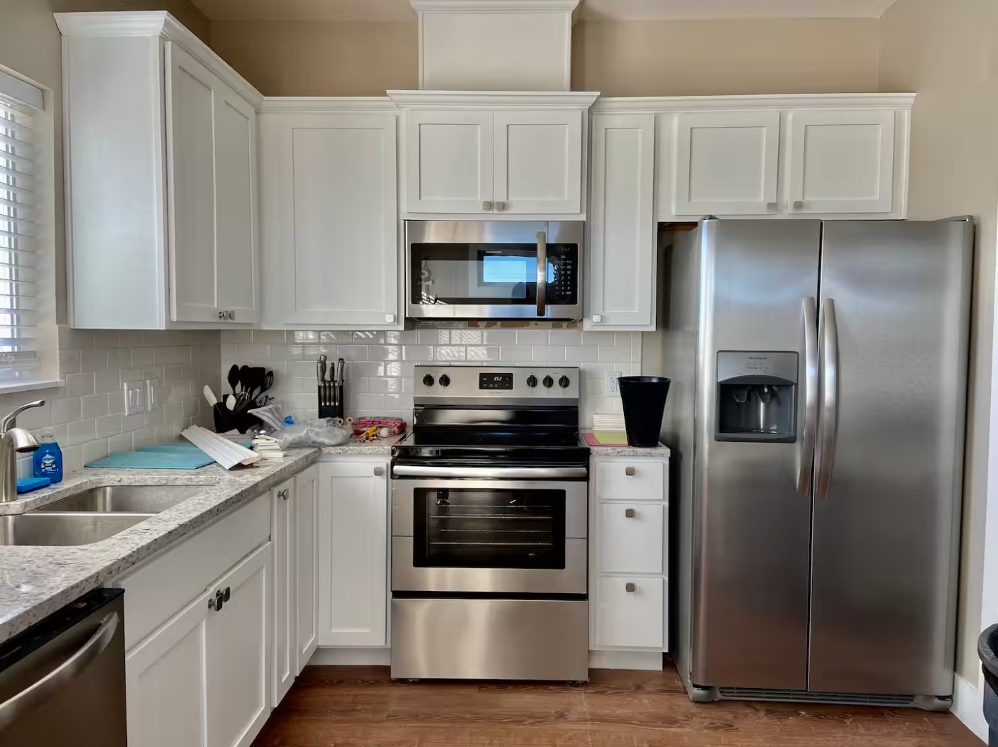 Kitchen with stainless steel appliances and white cabinets